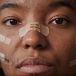 Self-Healing Synthetic Media: Building Resilient AI Pipelines Close-up of a woman with empowering messages written on facial bandages.