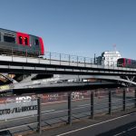 Sim2Real Optimal Transport for Distributed Ledgers Explained Electric train passing over Otto-Sill-Brücke, Hamburg, Germany with cityscape backdrop.