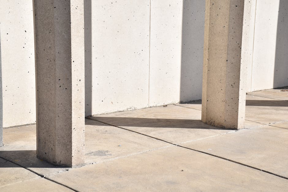 Abstract view of concrete pillars casting shadows on a smooth surface in Logan, Utah.
