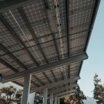 Solid-State Battery Frameworks for Quantum Tech Safety Low-angle view of solar panels under a clear sky, highlighting clean energy.