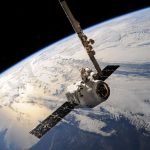 A satellite glides over Earth showcasing dramatic cloud formations and the vast expanse of space.