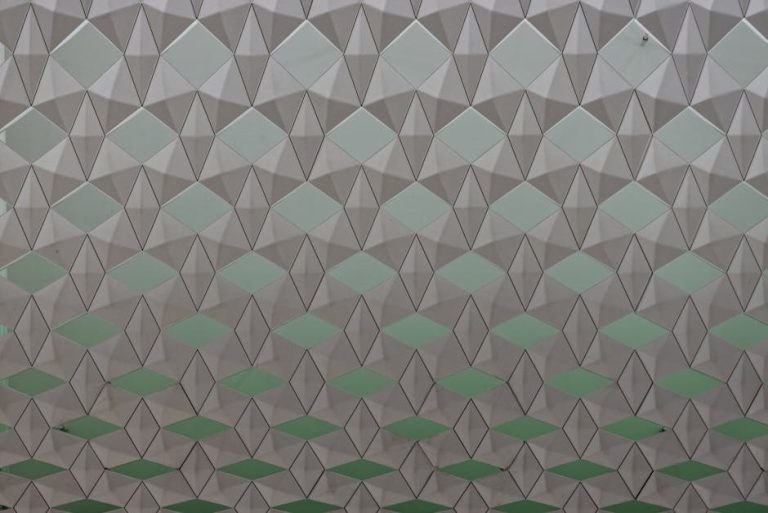 Seamless geometric pattern featuring diamond shapes in a soft color gradient.