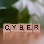 Symbol-Grounded Cybersecurity: Semantic Intent Analysis Guide Wooden letter tiles spelling 'CYBER' on a blurred background, representing cybersecurity.