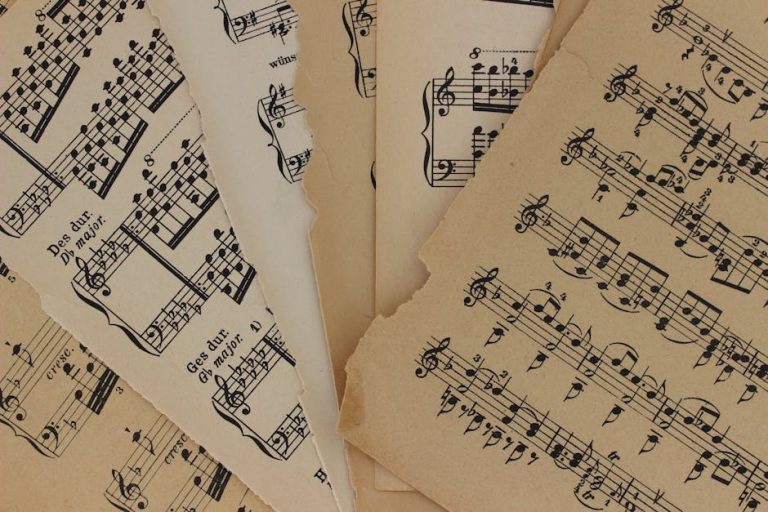 Close-up of vintage sheet music with torn edges, highlighting musical notations and history.