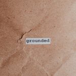 AI Breakthrough: Symbol-Grounded Theory of Mind in Nanotech Textured brown surface with the word 'grounded', conveying stability and mindfulness.