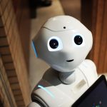The AI Edge: Why Political Strategy Now Requires Algorithmic Rigor A futuristic humanoid robot in an indoor Tokyo setting, showcasing modern technology.
