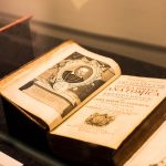 A vintage anatomy book displayed in a museum, showcasing detailed historical illustrations.