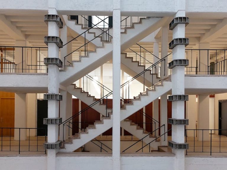 A symmetrical concrete staircase with industrial design in a modern building interior.