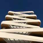 <h1>The Architecture of Thought: Decentralized Category Theory for Neuroscience</h1> Striking low-angle view of a modern high-rise building in Madrid against a clear blue sky.