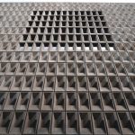 <h1>The Architecture of Trust: Building a Cellular Robotics Benchmark for Economics and Policy</h1> Concrete building facade with geometric patterns and recessed windows, showcasing modern architecture.
