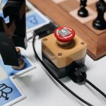 Close-up of a robotic arm interacting with a chess setup showcasing AI innovation.