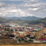 <h1>The Autonomous Climate Adaptation Compiler: Engineering Resilient Supply Chains</h1> A breathtaking view of a town nestled in the Crimean mountains with a dramatic cloudy sky.