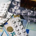 The Bio-Economic Frontier: How Medical Innovation Drives Strategy Blister packs of medication placed on Euro banknotes, illustrating healthcare expenses.