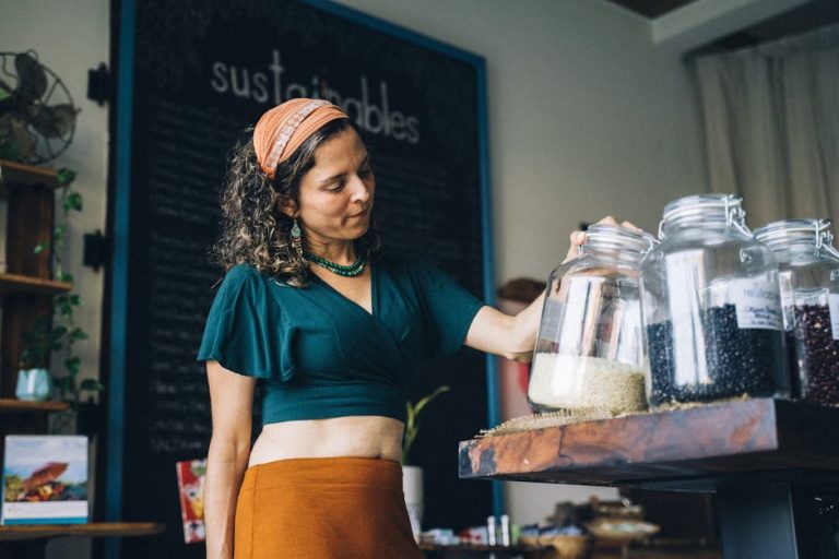 A woman replenishing glass jars with grains in an eco-friendly store, promoting zero-waste shopping.