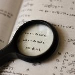 <h1>The Convergence of Calculus and CRISPR: Building a Physics-Informed Gene Editing Toolchain</h1> A magnifying glass focusing on mathematical equations in a textbook, symbolizing detailed study.