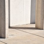 Abstract view of concrete pillars casting shadows on a smooth surface in Logan, Utah.