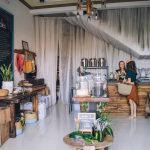 A cozy eco-friendly store with sustainable goods and two people interacting.