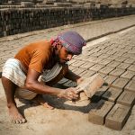 The Ethical Architecture of Social Media: A Leadership Guide An artisan assembles bricks in a sunny outdoor kiln, showcasing traditional craftsmanship.