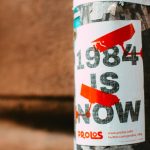 The Evolution of Surveillance: From Dystopian Fiction to Operational Reality Street poster with '1984 is Now' theme highlighting surveillance in urban setting.