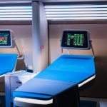 <h1>The Future of Healthcare: Simulation-to-Reality Nanotechnology in Hospital-at-Home Models</h1> A modern hospital room featuring advanced medical equipment with digital displays.