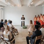 A diverse choir performs indoors under soft lighting. Spiritual atmosphere.