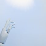 <h1>The Future of Precision: Building Edge-Native Autonomous Logistics for Bioelectronics</h1> A robotic hand reaching towards a bright light on a white background symbolizing innovation.
