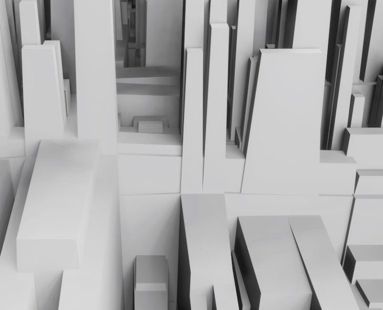 Aerial view of a 3D abstract cityscape with geometric shapes in grayscale tones.