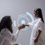 A mother and daughter connect through digital technology in a modern setting.