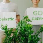 <h1>The Green Revolution 2.0: Benchmarking Safety-Aligned Synthetic Fertilizers for Policy and Profit</h1> Two people holding eco-friendly signs promoting sustainability and going green.