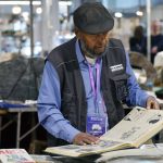 The Historian’s Toolkit: Strategic Storytelling for Leaders Man wearing a hat and vest browsing vintage books at an indoor market.