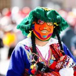 A vibrant dancer with a mask at a traditional festival in Cusco, Peru.