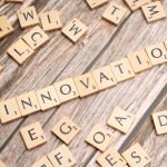 The Innovation Paradox: How New Tech Reshapes Organizational Culture Creative display of 'Innovation' spelled with wooden letter tiles on a wooden surface.