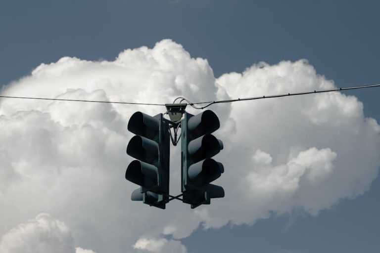 A traffic light suspended against a backdrop of dramatic clouds in Palermo, Sicily.