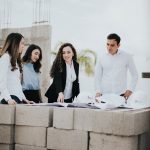 The Media Architect: How Leadership Shapes Information Ecosystems Architectural team reviewing blueprints at a construction site in Los Mochis, Mexico.