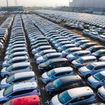 The New Economic Order: How Modern Leadership Drives Market Shifts From above of many rows with prestige modern shiny automobiles of manufacture in daytime