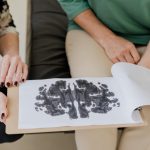The Psychology of Deep Space: Lessons for High-Performance Leadership A close-up of a Rorschach inkblot test during a psychotherapy session, highlighting mental health care.