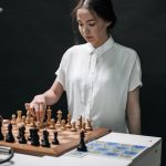 The Science of Creativity: A Strategic Framework for Leaders A woman plays chess with a robotic arm, illustrating technology and strategy in a modern context.