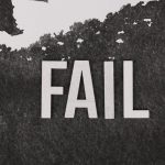 Grayscale image of the word 'FAIL' on a textured, monochrome background.