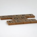 The Strategic Advantage of Failure: Historical Lessons for Leaders Scrabble tiles spelling 'Adapt or Fail' on a plain background, symbolizing decision-making.