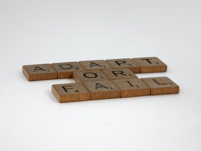 Scrabble tiles spelling 'Adapt or Fail' on a plain background, symbolizing decision-making.