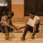 The Strategic Architecture of Social Media in Modern Business Two young men playing chess on steps outdoors in Ado Ekiti, Nigeria.