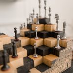 The Strategic Architecture of Storytelling: Lessons from Art History 3D chessboard with metal chess pieces on a wooden tiered design, showcasing creativity.
