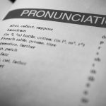 The Strategic Edge: Why Linguistic Capital Drives Market Expansion Black and white close-up of a dictionary page focused on pronunciation guides and phonetic symbols.