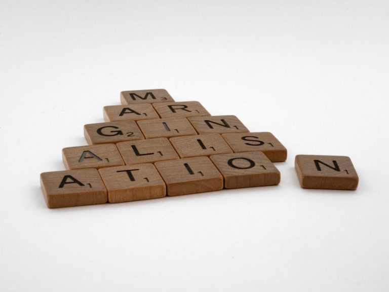 Wooden Scrabble tiles spelling 'IMAGINATION' arranged on a white background.