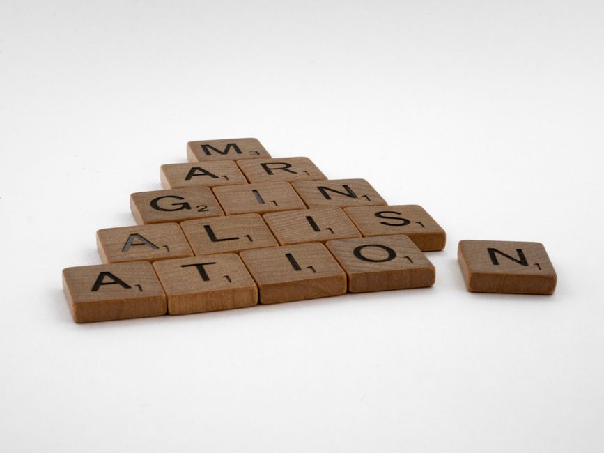 Wooden Scrabble tiles spelling 'IMAGINATION' arranged on a white background.