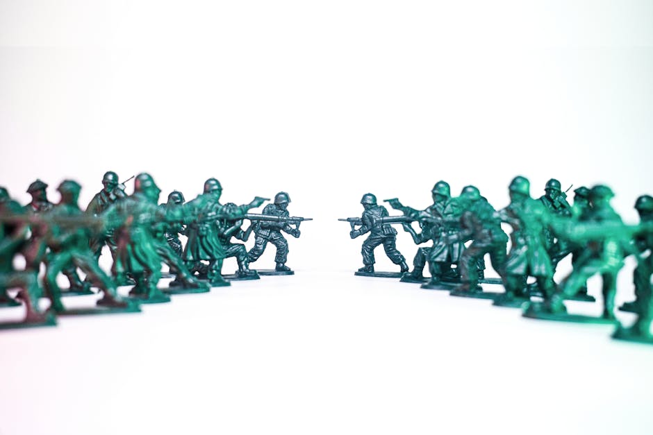 Green toy soldiers facing off on a white background, symbolic of conflict and strategy.
