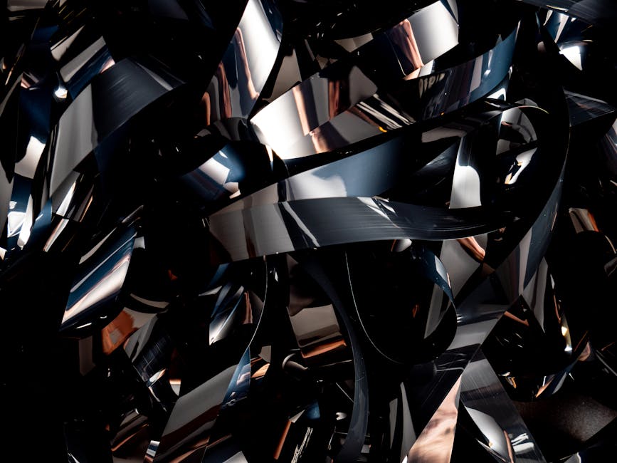 A close-up of abstract black and reflective curved shapes with a futuristic design.