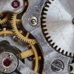 Detailed close-up of interlocking gears and cogs in a complex mechanical system.