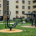 Urban Design and Wellness: Strategic Architecture for Performance Modern outdoor gym equipment in a residential courtyard, promoting fitness and healthy lifestyle.