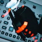 Verifiable BCI Control Policy: A Cognitive Science Framework Blurred dynamic shot of buttons and controls on modern music production equipment with glowing lights.